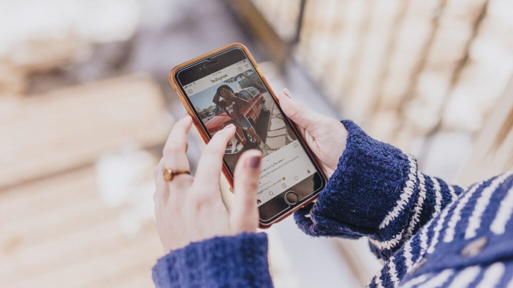 woman holding phone on social media