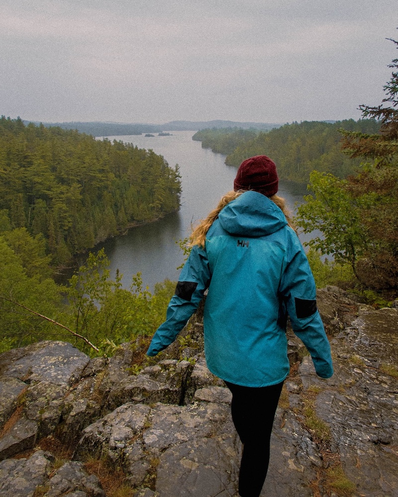 outdoor hiker from the back overlooking river through mountains